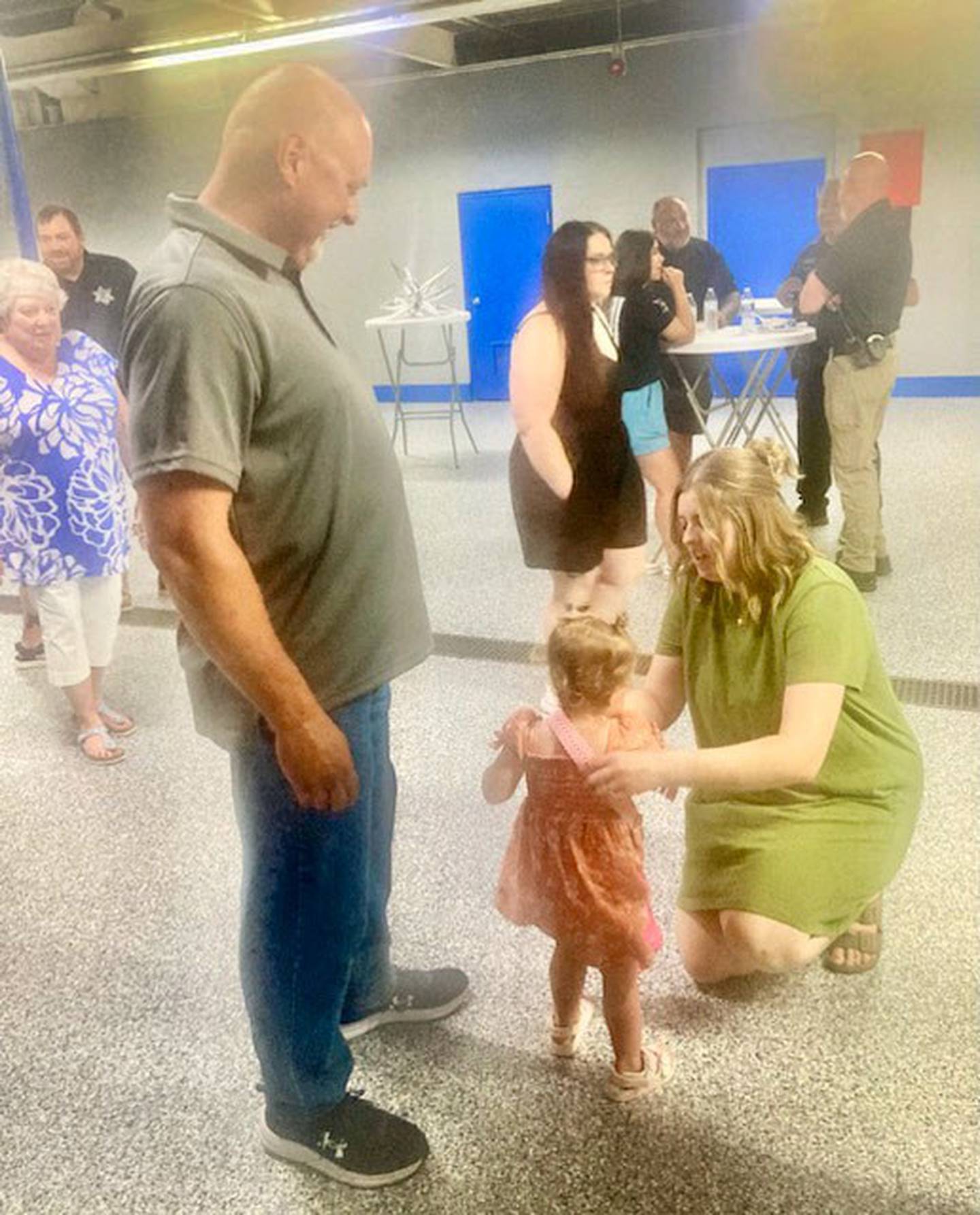 Erik Sorenson talks with his daughter, Miranda Layton and grand daughter, Posey, during his retirement open house. He is retiring after 27 years with the Princeton Police Department, 30 years in law enforcement.