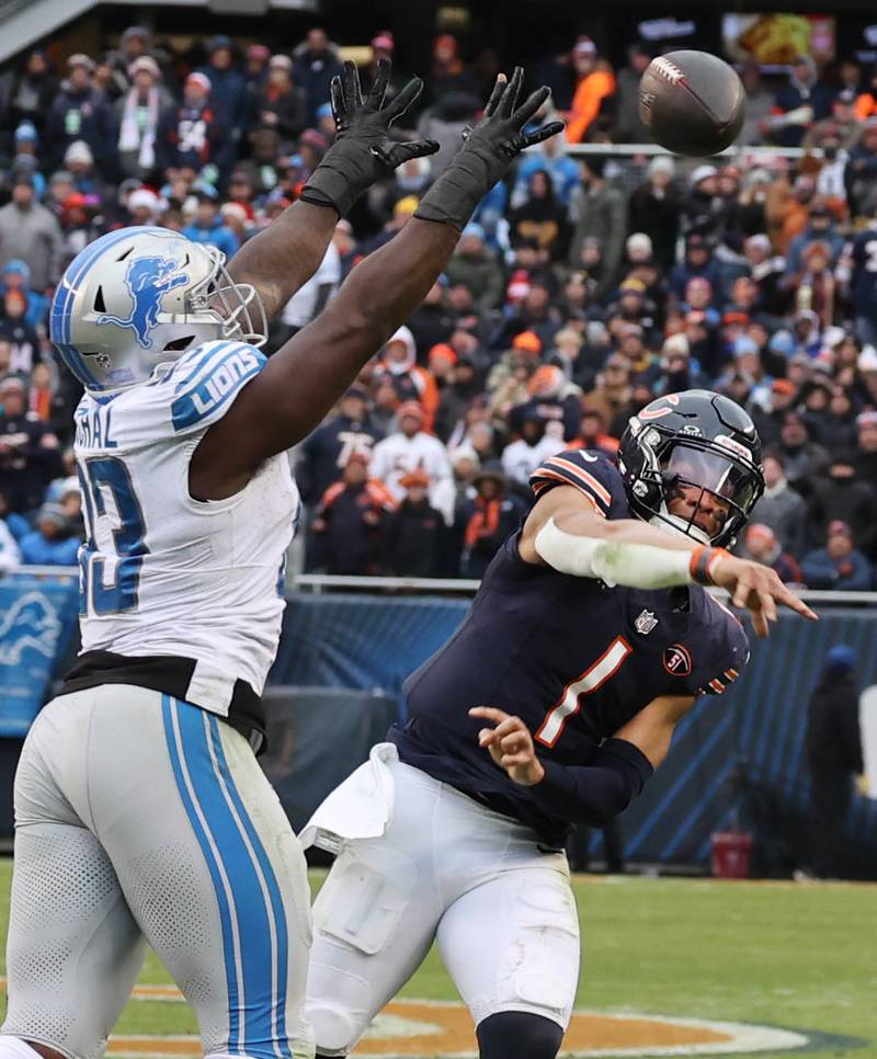 Chicago Bears quarterback Justin Fields gets a pass off just before being hit by Detroit Lions defensive end Josh Paschal during their game Sunday, Dec. 10, 2023 at Soldier Field in Chicago.