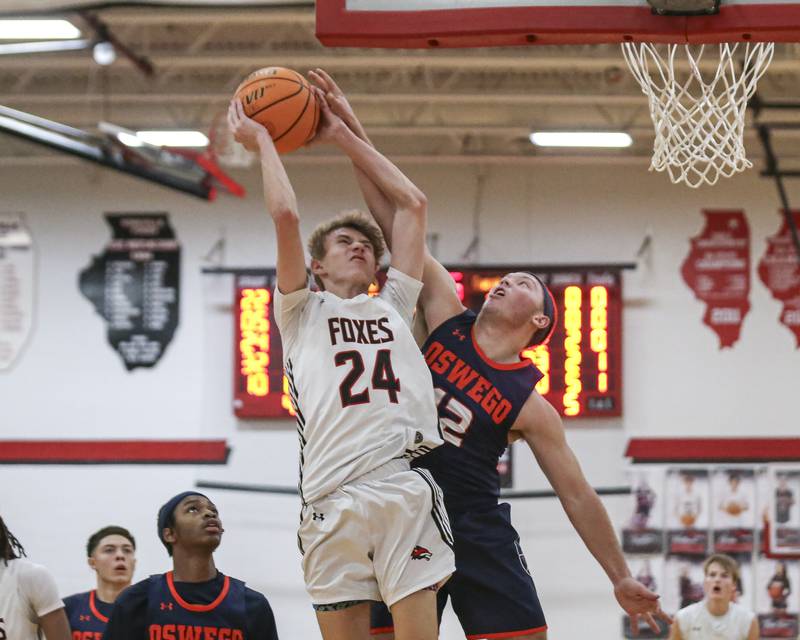 Yorkville's Nathan Kubin (24) is challenged by Oswego's Graham Schwab (12) on a shot during their basketball game between Oswego at Yorkville Friday, Dec 12, 2025 in Yorkville.