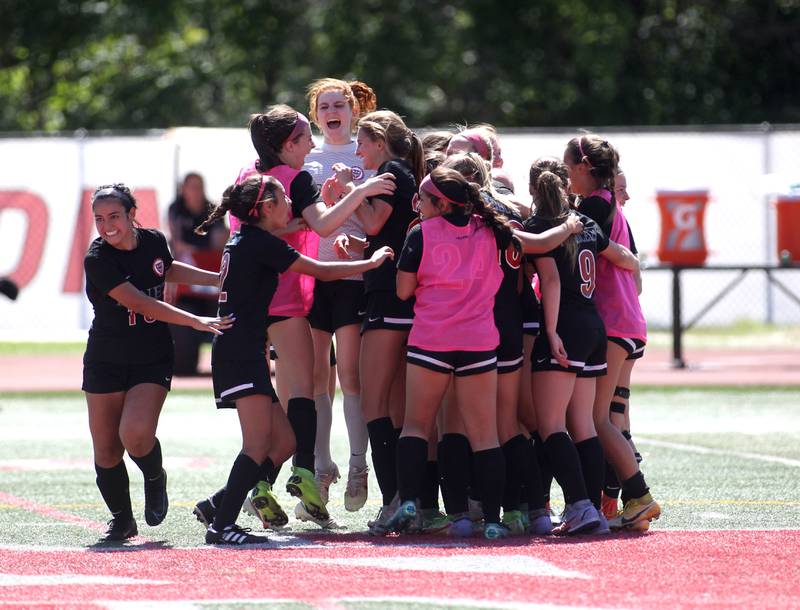 Benet players celebrate their IHSA Class 2A state semifinal win over Deerfield at North Central College in Naperville on Friday, June 3, 2022.