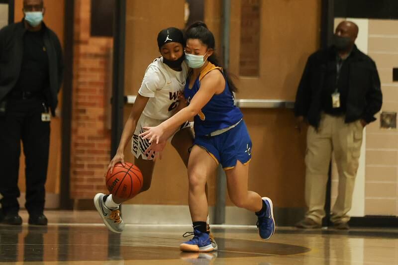 Joliet West’s Lisa Thompson and Joliet Central’s Lillian Luangsomkham collide going for the ball. Tuesday, Feb. 8, 2022, in Joliet.