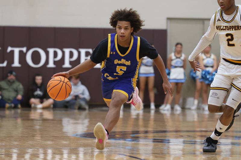 Joliet Central’s Michael Stokes sprints up court with the ball against Joliet Catholic on Tuesday, Jan 20, 2026 in Joliet.