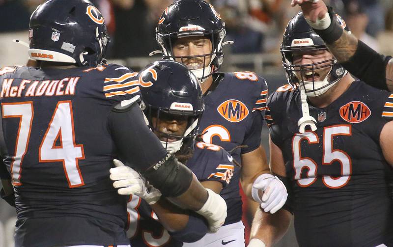 Chicago Bears Ian Wheeler, (center) gets congratulated by his teammates Jordan McFadden, Joel Wilson and Luke Newman after scoring a touchdown on Sunday, Aug. 17, 2025 at Soldier Field in Chicago.
