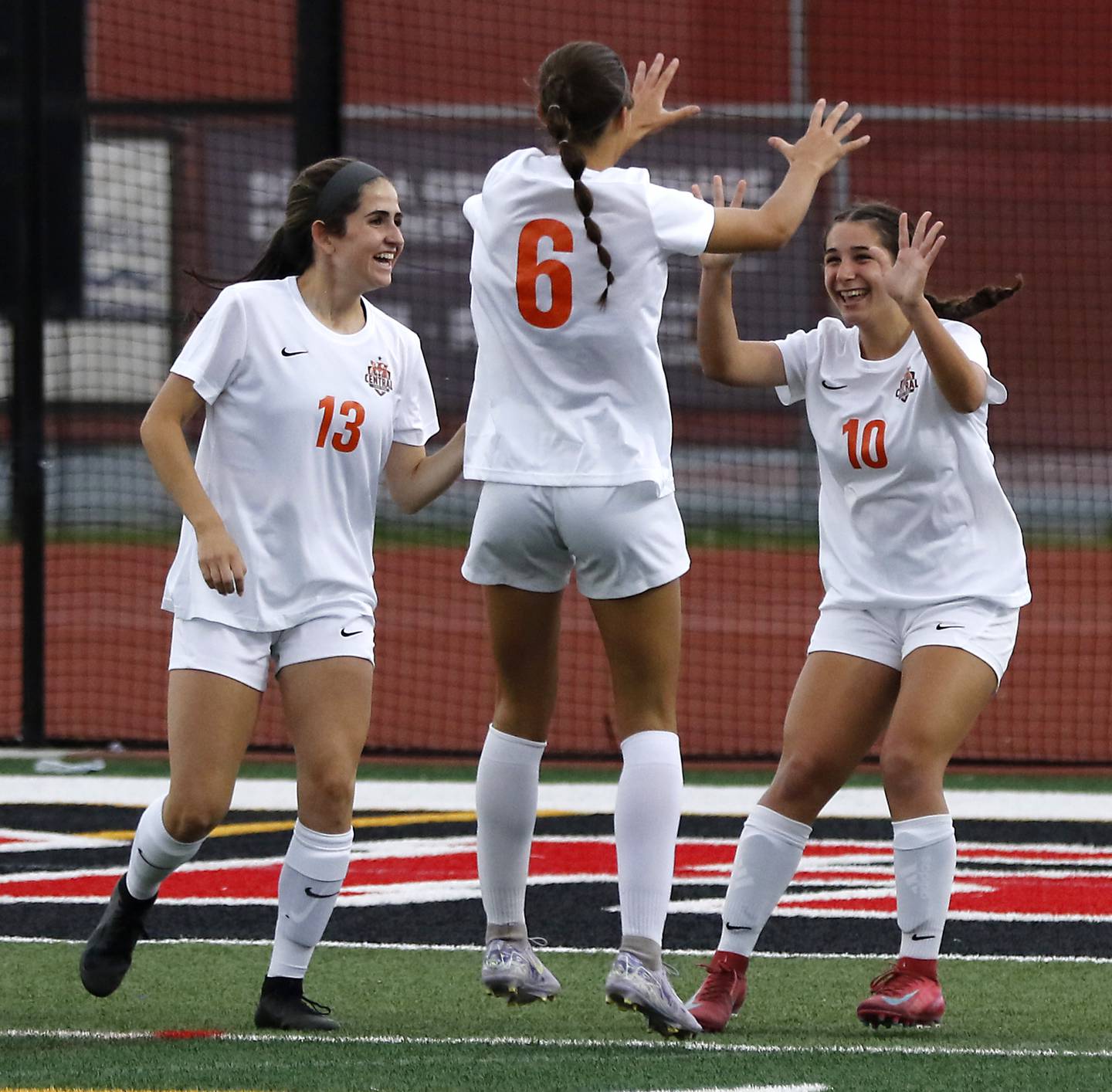 Crystal Lake Central's Jordin Gaunaurd, (left) Ella Bechler, (center) and Addison Schaffer celebrate Schaffer’s goal in the first half of the IHSA Class 2A Deerfield Sectional championship girls soccer match against St. Viator on Friday, May 30, 2025, at Deerfield High School.