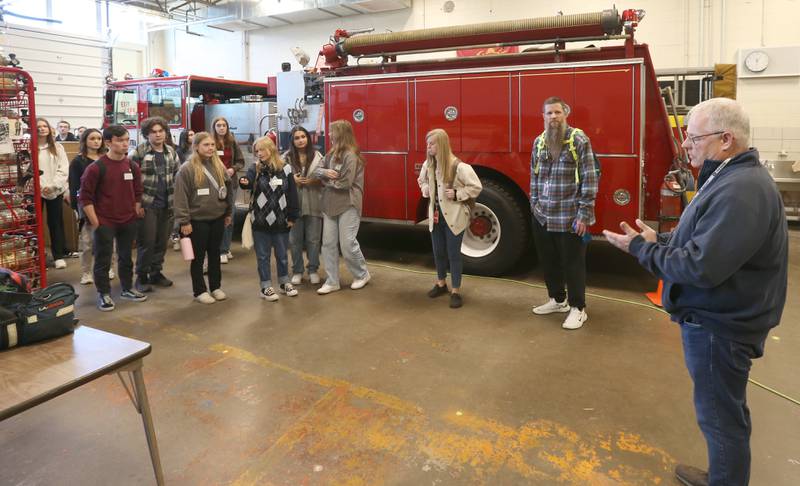 Naperville Central students tour the L-P Area Career Center fire science program on Tuesday, April 18, 2023 at L-P High School as instructor Chris Saarr (right) talks about careers with fire science.