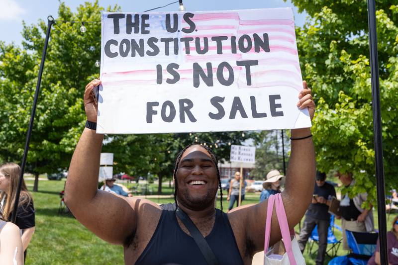 Protester holds sign at the “No Kings” protest on Saturday, June 14, 2025 at Rotary Park in Princeton.