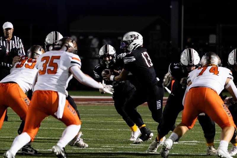 Plainfield North's Justus Byrd hands off the ball to Devan Skuja during the Oct. 11 game against Minooka held at Plainfield North.