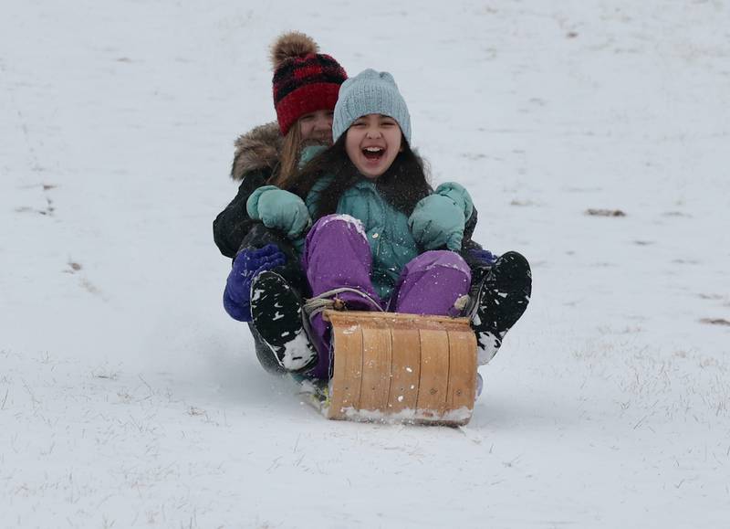 Molly Casiano, (front) 9, and Alex Schwantes, 15, both from DeKalb, enjoy the sled hill Wednesday, Feb. 12, 2025, at Hopkins Park in DeKalb.