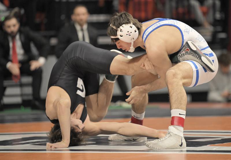 Marmion’s Demetrios Carrera wrestles Grant’s Vince Jasinski in the Class 3A 144-pound bout at the boys IHSA wrestling finals at State Farm Center in Champaign on Saturday, Feb. 21, 2026.