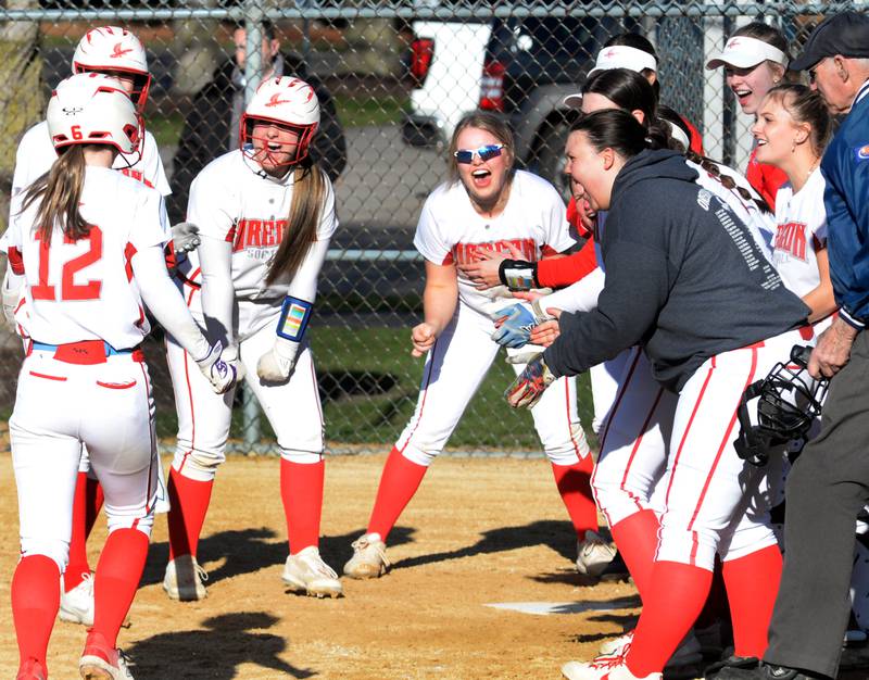 Oregon's Ella Dannhorn is greeted by her teammates at home plate after hitting a home run against Dixon on Friday, April 5, 2024 at Oregon Park West.