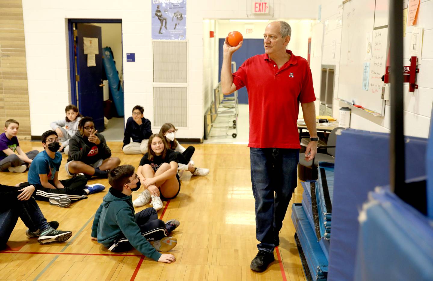 Physical education teacher Corey Toppel teaches a lesson on the shot put to sixth graders at Glen Crest MIddle School in Glen Ellyn. Toppel has been a teacher at the school for 32 years.