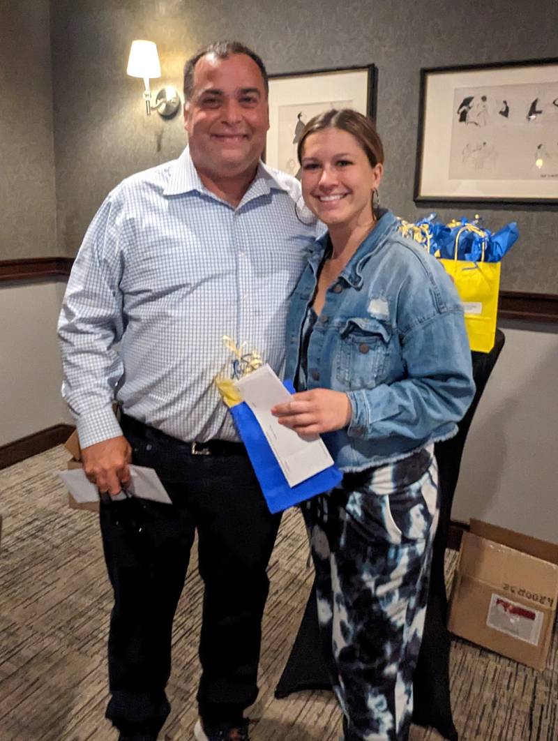 Mike Krzak presents Erica Burgess with a $1,000 check at the La Salle Elementary Schools luncheon.
