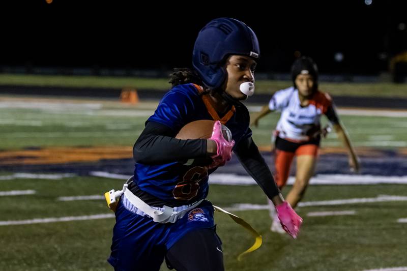 Romeoville's Milan Cadet picks-up yardage during a varsity flag football Romeoville Regional semifinal game at Romeoville on Oct. 7, 2025.