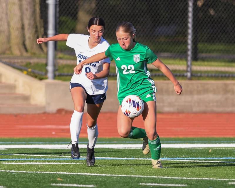 Downers Grove South's Gianna Lamb (9) and York's Avery O'Brien (22) battle for the ball during the regional title game on Friday May 23, 2025, held at York High School.