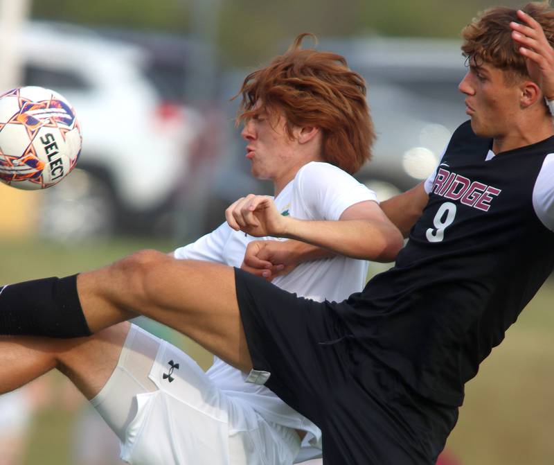 Crystal Lake South’s Pierce Johnson battles Prairie Ridge’s Henry Knoll, right, in varsity soccer on Thursday, Sept. 19, 2024, at Prairie Ridge High School in Crystal Lake.