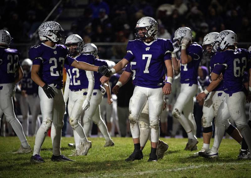 Wilmington's Cooper Holman, center, and Hunter Kaitschuk, left, react after a play in the Class 2A semifinal against El Paso-Gridley on Saturday, November 22, 2025.