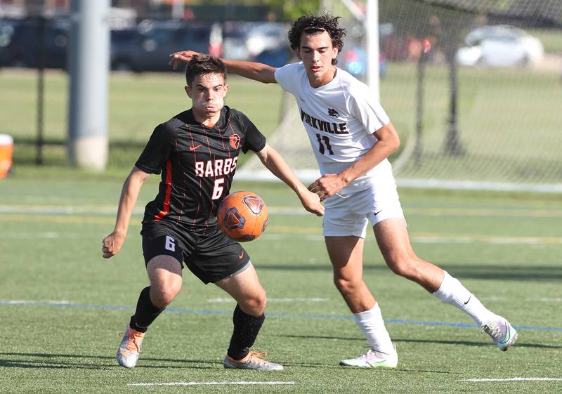 DeKalb's Landon Weishaar and Yorkville's Lukas Kleronomos go after the ball during their game Thursday, Aug. 25, 2022, in the Barb Cup at the Northern Illinois University Outdoor Recreation Sports Complex.