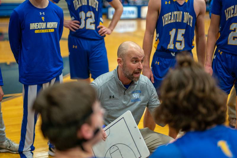 Wheaton North's head coach Dave Brackmann talks to his players during a break in play against Geneva during a basketball game at Geneva High School on Friday, Jan 6, 2023.