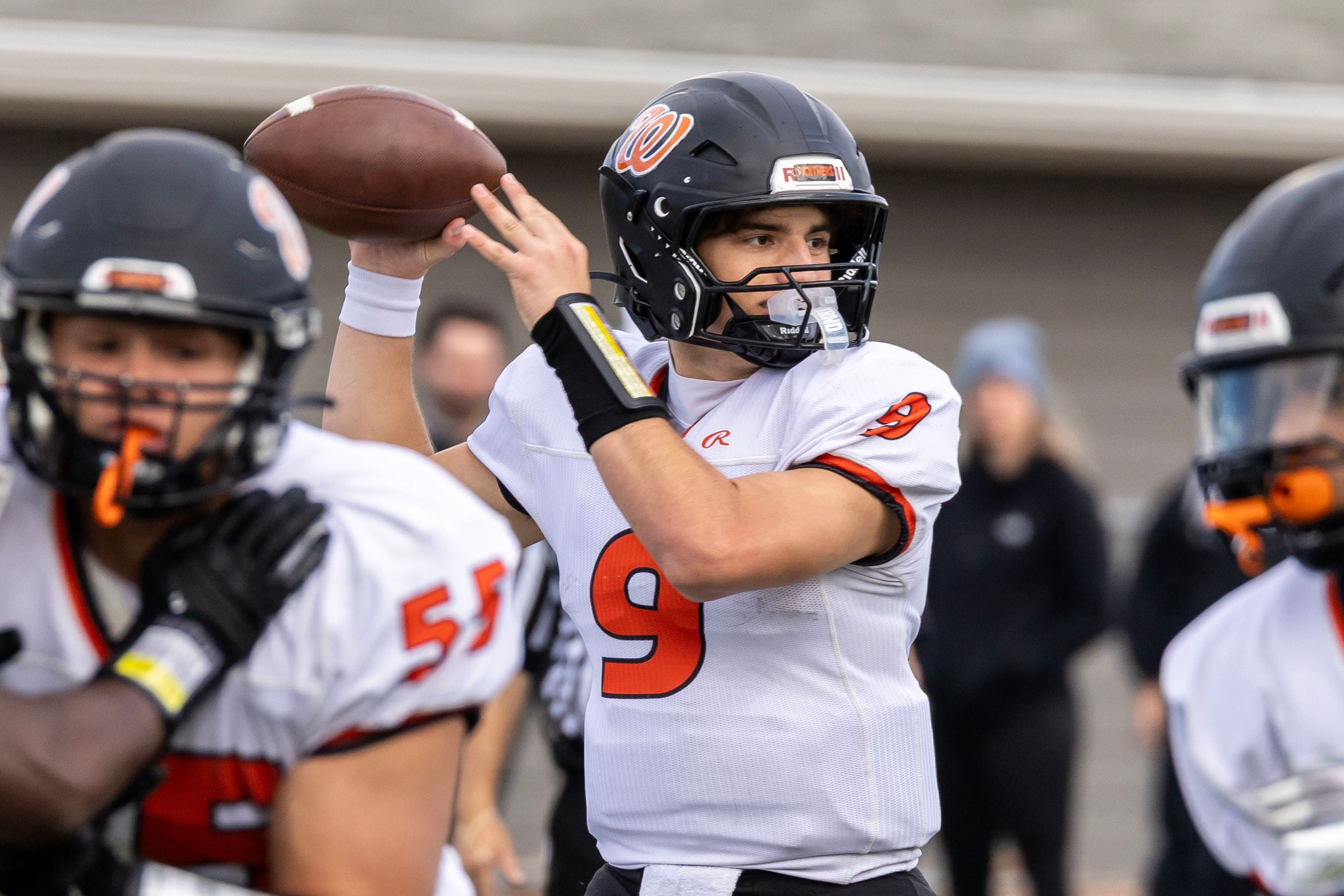 Washington's Noah Garcia looks for an open teammate during a 5A varsity football playoff game against Providence at Providence on Nov. 15, 2025.