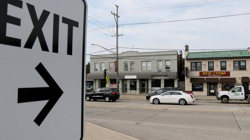 Cars drive on Northwest Highway in Fox River Grove, where village officials are attempting to purchase commercial property across from the Metra station, on Thursday, July 12, 2018 in Fox River Grove.