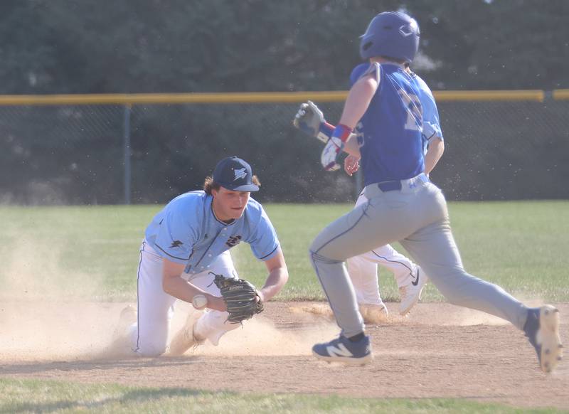 Bureau Valley's Blake Foster bobbles the ball as Newman's Liam Nicklaus runs to the bag on Monday, March 30, 2026 at Bureau Valley High School.