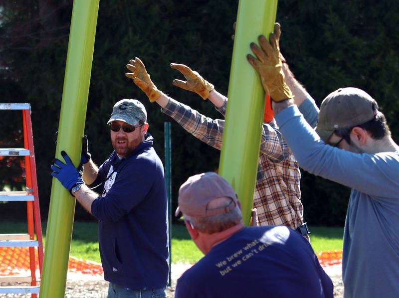 Volunteers and friends of Three Oaks Elementary School constructed a new playground at the Cary school on Saturday.