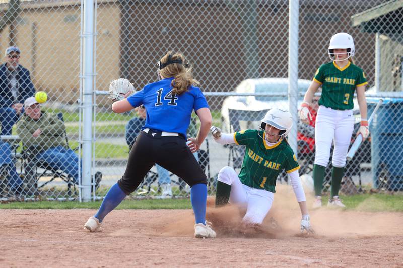 Grant Park's Claire Sluis scores a run as Milford/Cissna Park's Ellie Schwartz awaits the throw during Grant Park's 12-2 victory in six innings on Wednesday, March 25, 2026.