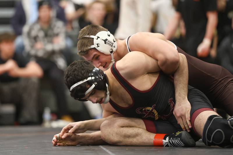 Joliet Catholic’s Matthew Laird works over Lockport’s Naseem Jaber in the Class 3A Minooka Regional 144 pound championship on Saturday, Jan. 31, 2026 in Minooka.