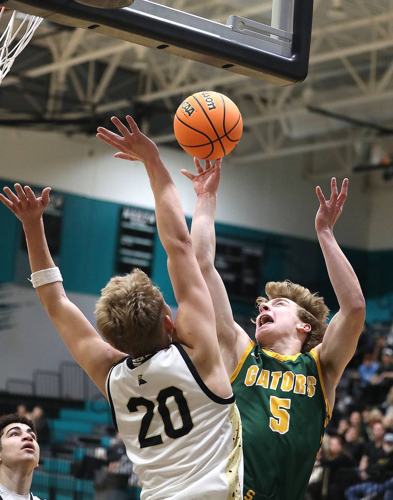 Crystal Lake South's Carson Trivellini (right) shoots the ball over Sycamore's Isaiah Feuerbach during an IHSA Class 3A Woodstock North Sectional semifinal.basketball game on Wednesday, March 4, 2025, at Woodstock North High School.
