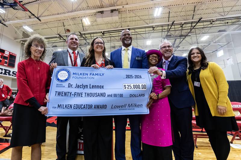 Dr. Jaclyn Lennox, Bolingbrook High School’s assistant principal of curriculum and instruction, poses for a photo with school an state administrators and Milken Educator Awards representatives after winning the Milken Educator Award during a surprise assembly at Bolingbrook High School on Oct. 16, 2025.