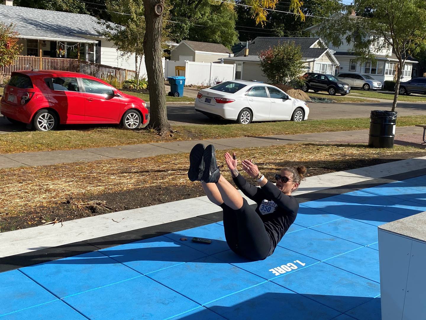Sarah Nanouski demonstrates an exercise at the ribbon cutting for the new fitness court at Kiwanis Park in Ottawa.