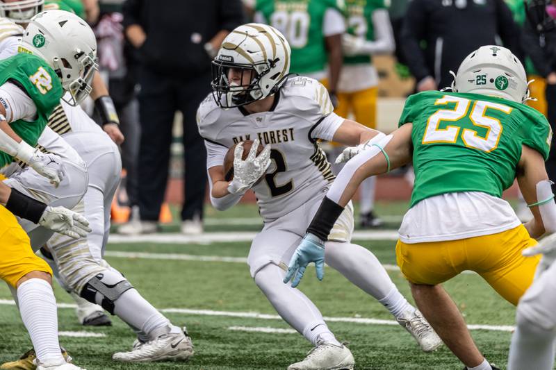 Oak Forest's William McMaster looks for an opening during a 5A varsity football semifinal game against Providence at Providence Catholic High School on Nov. 22, 2025.