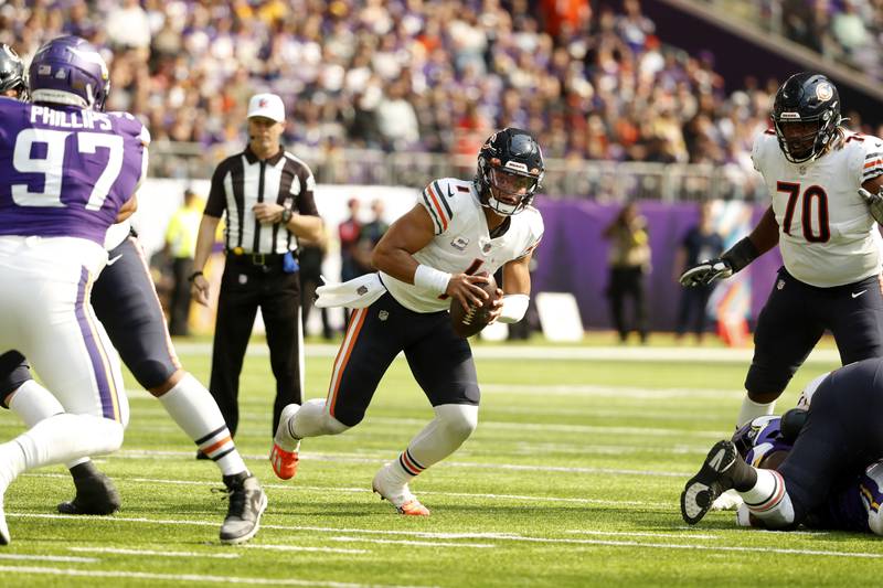 Chicago Bears quarterback Justin Fields scrambles up field during the first half against the Minnesota Vikings, Sunday, Oct. 9, 2022, in Minneapolis.