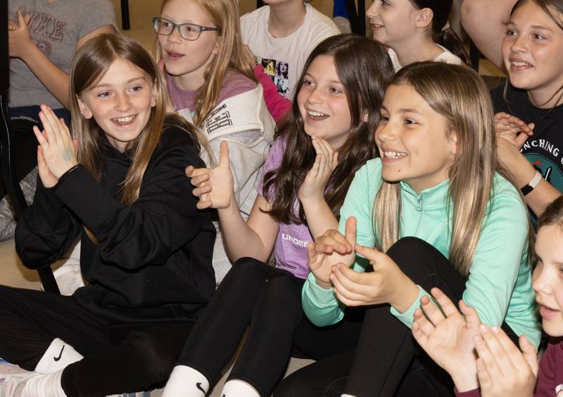 Fifth graders Emery Ganiere, Maddison Jenkins and Bella Zuber enthusiastically cheer for their classmate's Elvis performance Tuesday afternoon. In between the three-song performance the crowed chanted "Elvis! Elvis!"