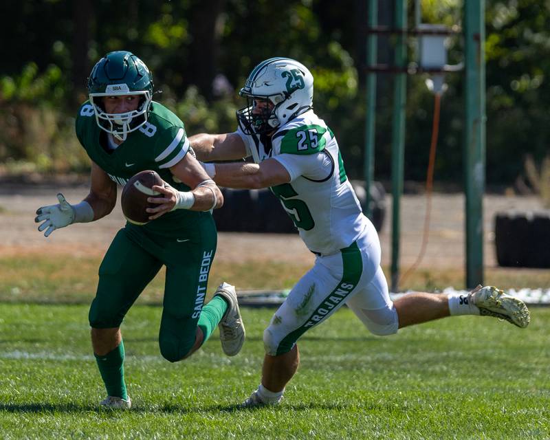 Gino Ferrari (8) of St. Bede runs ball as Ayden Collom (25) of Dwight trails on Saturday, Oct. 4, 2025 at Captain Thomas J. Heitmann field in Peru.