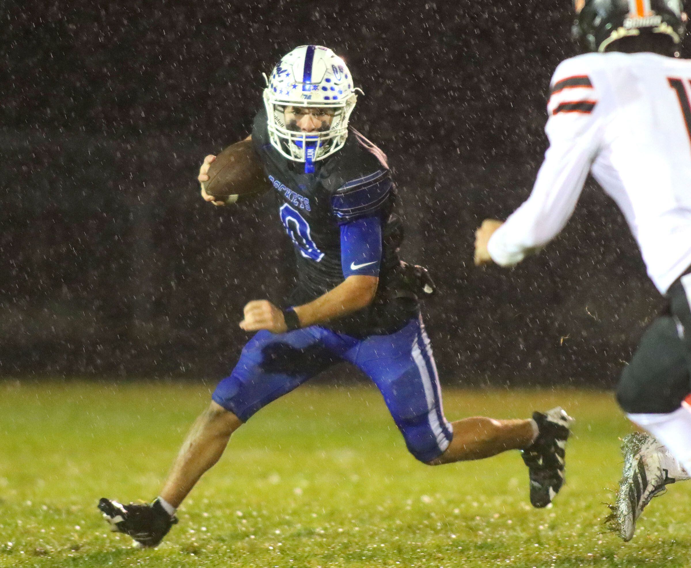 Burlington Central’s Henry Deering moves the ball against Harlem in IHSA football Class 6A second-round playoff action at Central High School in Burlington on Saturday, November 8, 2025.