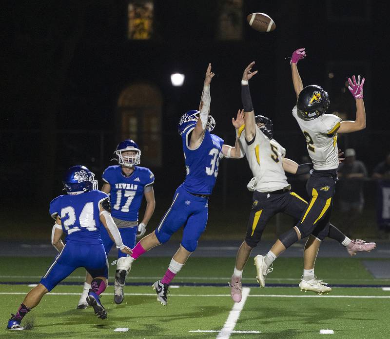 Newman and Riverdale players leap for a pass thrown by the Riverdale QB Friday, October 11, 2024.