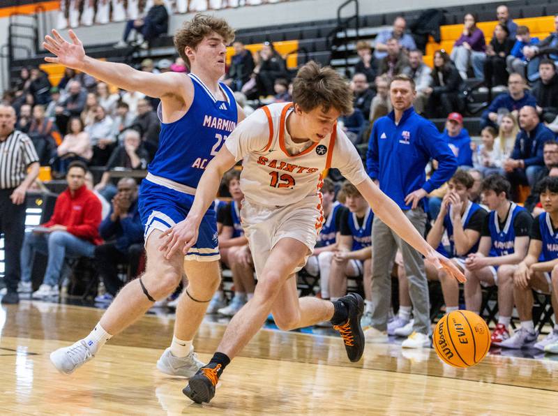St. Charles East forward Cooper Jensen drives the lane during a game against Marmion Academy on Saturday, Jan. 4, 2025.