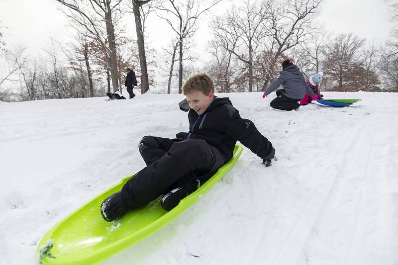 Kellen Kibodeaux, 10, of Rock Falls gets some push behind his sled Wednesday, Jan. 25, 2023 at Sinnissippi Park in Sterling. The Sauk Valley woke up to several inches of snow that coated the trees.