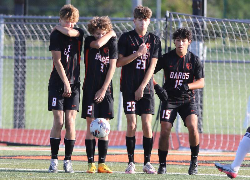 DeKalb players protect themselves as they line up to block an Auburn free kick during their game Thursday, Sept. 22, 2022, at DeKalb High School.