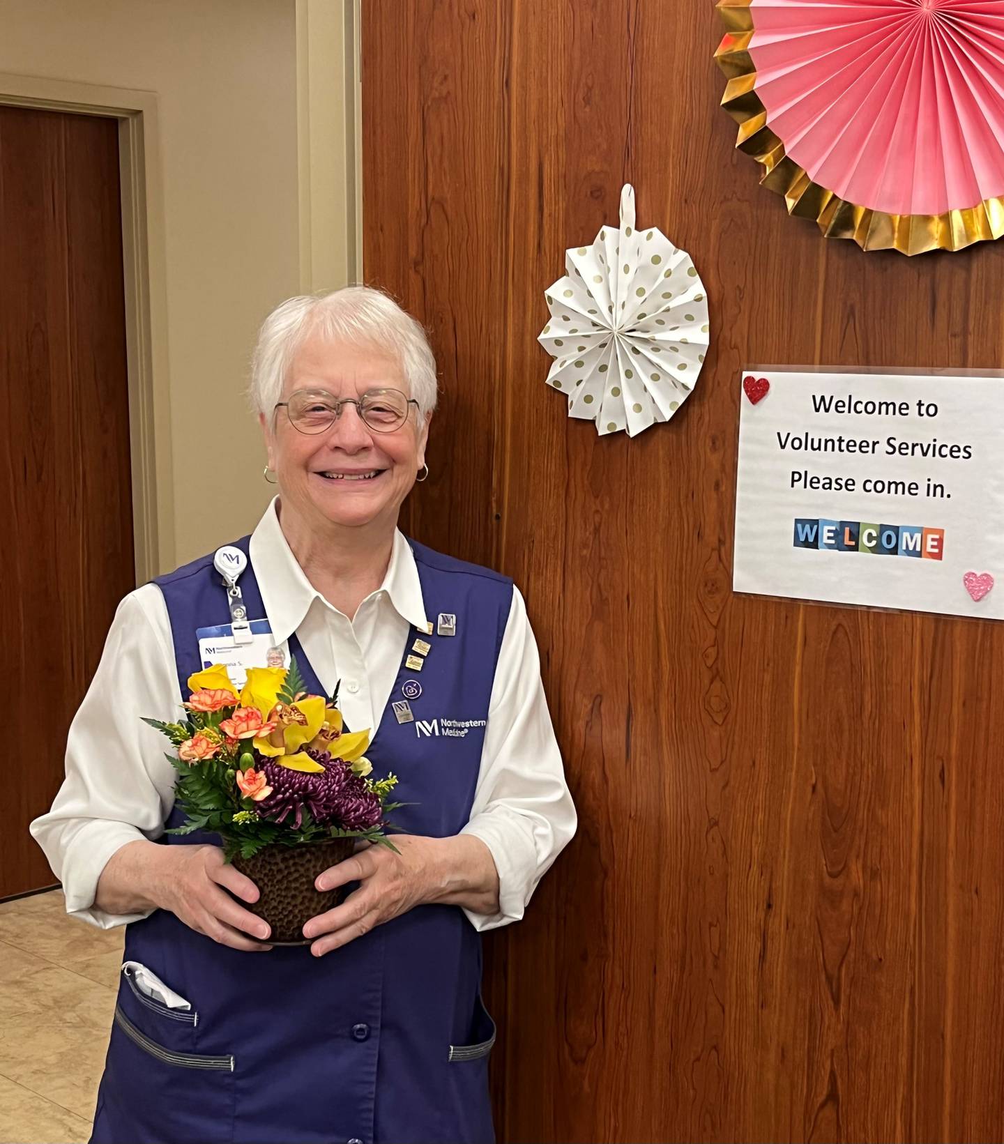 Northwestern Medicine Delnor Hospital volunteer Donna Scott delivers flowers during a shift.