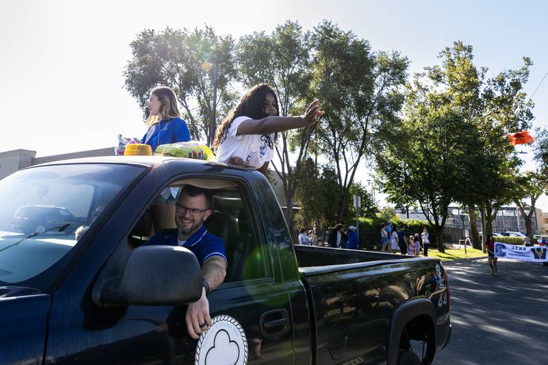 Freshman homecoming court members Reagan Schneider and Sasha McKenzie ride in a truck driven by Kevin Fitzgerald, Director of Athletics & Activities, during the Joliet Central homecoming parade on Sept. 27. 2025.