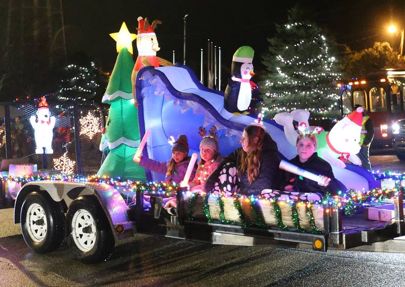 Children ride a float in the in the inaugural Lighted Christmas Parade on Friday, Dec. 1, 2023 in Princeton.