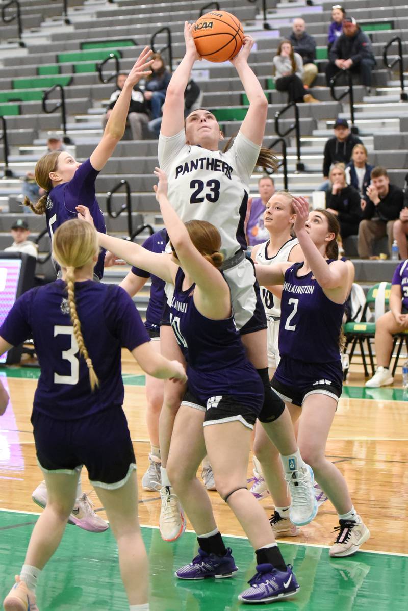 Manteno's Maddie Gesky (23) grabs an offensive rebound over a host of Wilmington defenders during the IHSA Class 2A Seneca Regional championship Thursday, Feb. 19, 2026.