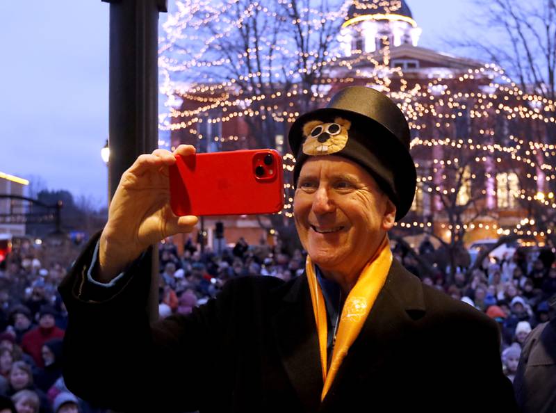 Groundhog Days Committee member Craig Krander records the festivities on Friday, Feb. 2, 2024, during the annual Groundhog Day Prognostication on the Woodstock Square.