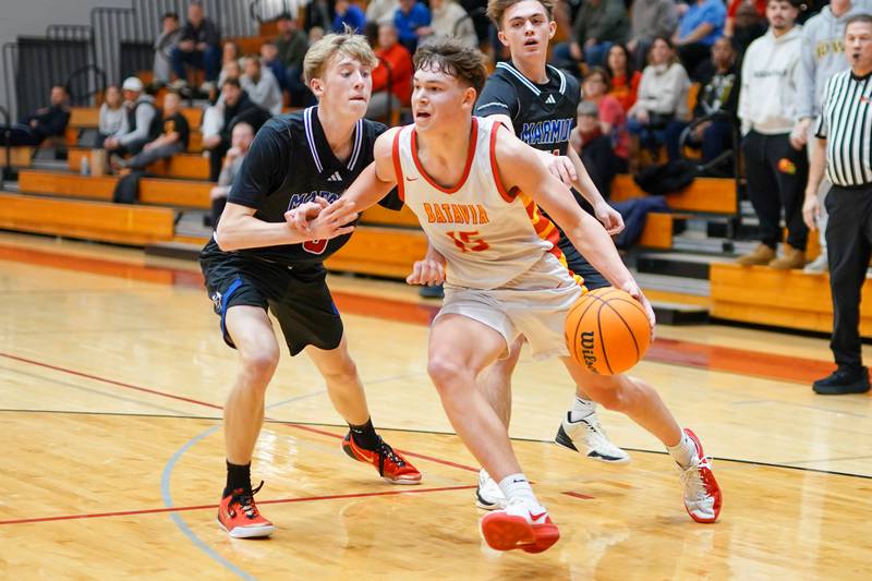 Batavia’s Dane Farrar (15) drives to the basket against Marmion's Nicholas Proctor (0) during a game at Batavia High School on Wednesday, Nov. 26, 2025.