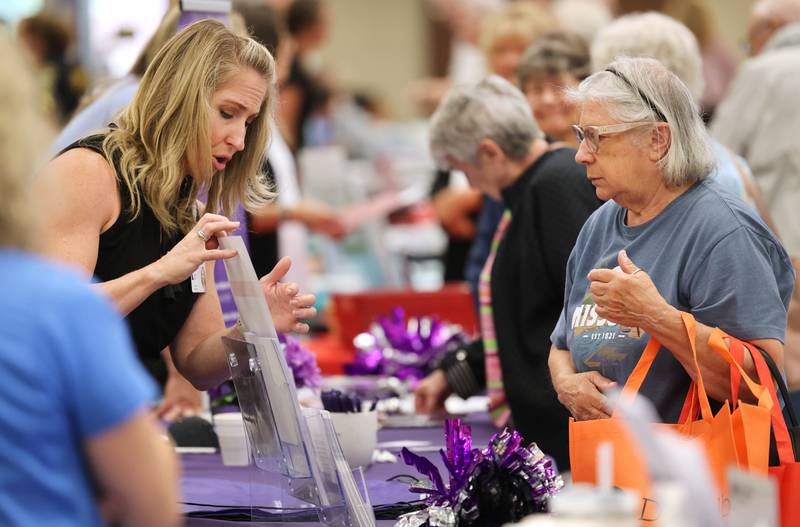 Northwestern Medicine Stroke Program Coordinator Caryn Josh talks to Christine Gruskovak, from Sycamore, during a senior health fair Wednesday, July 12, 2023, at DeKalb High School.