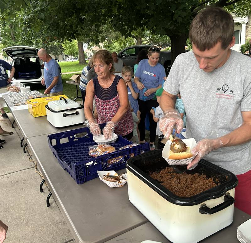 Derek Nelson, Brittany Drozd, and Gwen Zipse waited on customers at the St. James Lutheran food stand during the Jamboree Concert Series in Mt. Morris on Friday, July 25, 2025.