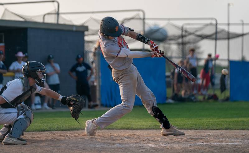 Oswego’s Tyler Stack (25) hits the ball deep driving in a two runs against Oswego East in the top of the 8th inning during a baseball game at Oswego East High School on Tuesday, May 10, 2022.