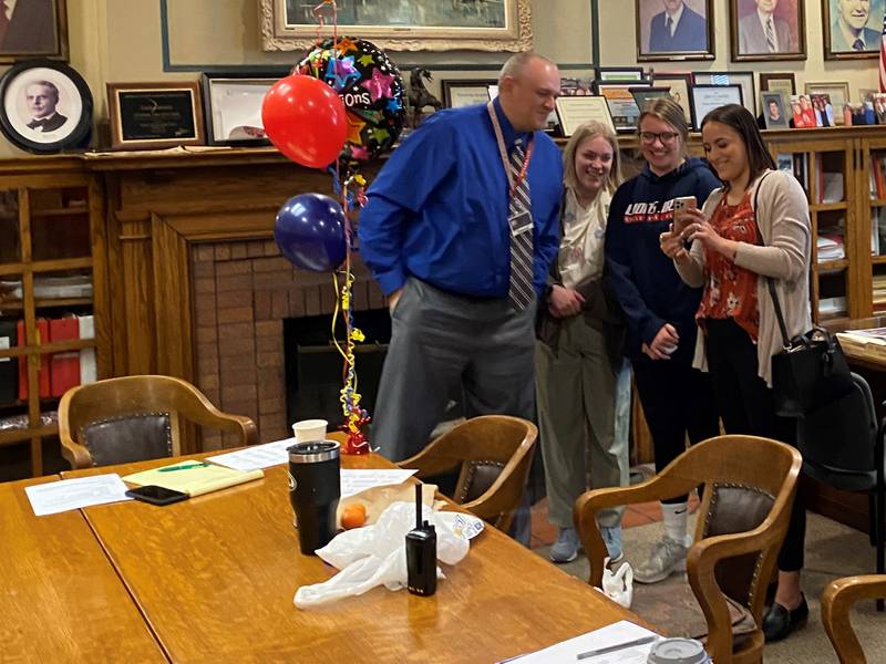 Principal Patrick Leonard celebrates being named the Illinois Principal Association's Principal of the year with his daughters, Shelby, Ainsley and Darby while his other kids, Ryan, Brady and Kiara join via Facetime.